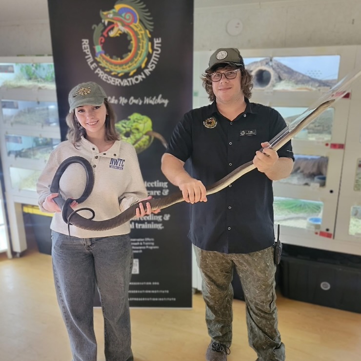 Reptile enthusiast and venomous snake handler Savannah Steel handling a Black Mamba alongside Cody Bartolini at the Reptile Preservation Institute in Melrose, Florida.